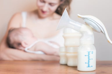 A woman breastfeeding her baby with breast pumps